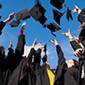 image of graduates throwing their caps in the air