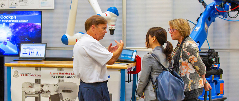 Researcher explaining technology to woman listening