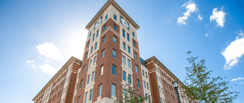 Campus Village building 1 clock tower as seen from the sidewalk beside building 3