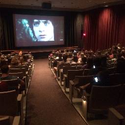 A group of people watching a movie.