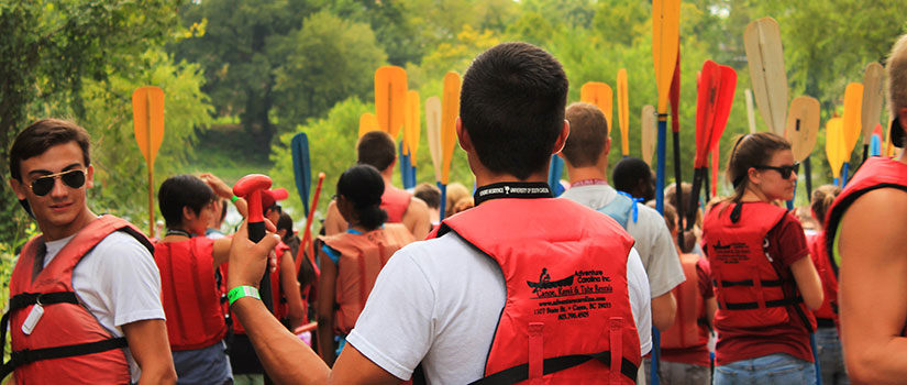 a group of UofSC students prepares to kayak one of Columbia's rivers