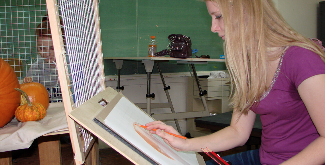 Students draw a pumpkin in the art class.