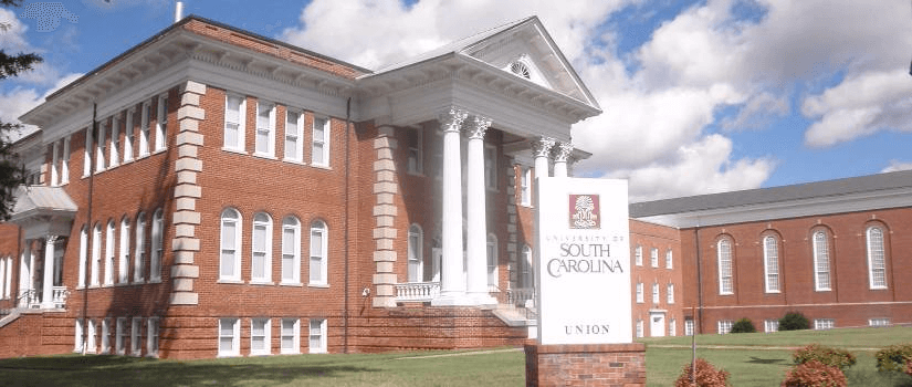 Sign reading "University of South Carolina Union" outside a large brick building with tall white columns on the university campus