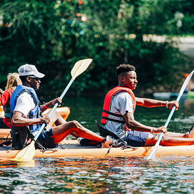 Students kayaking on the river during Floatilla.