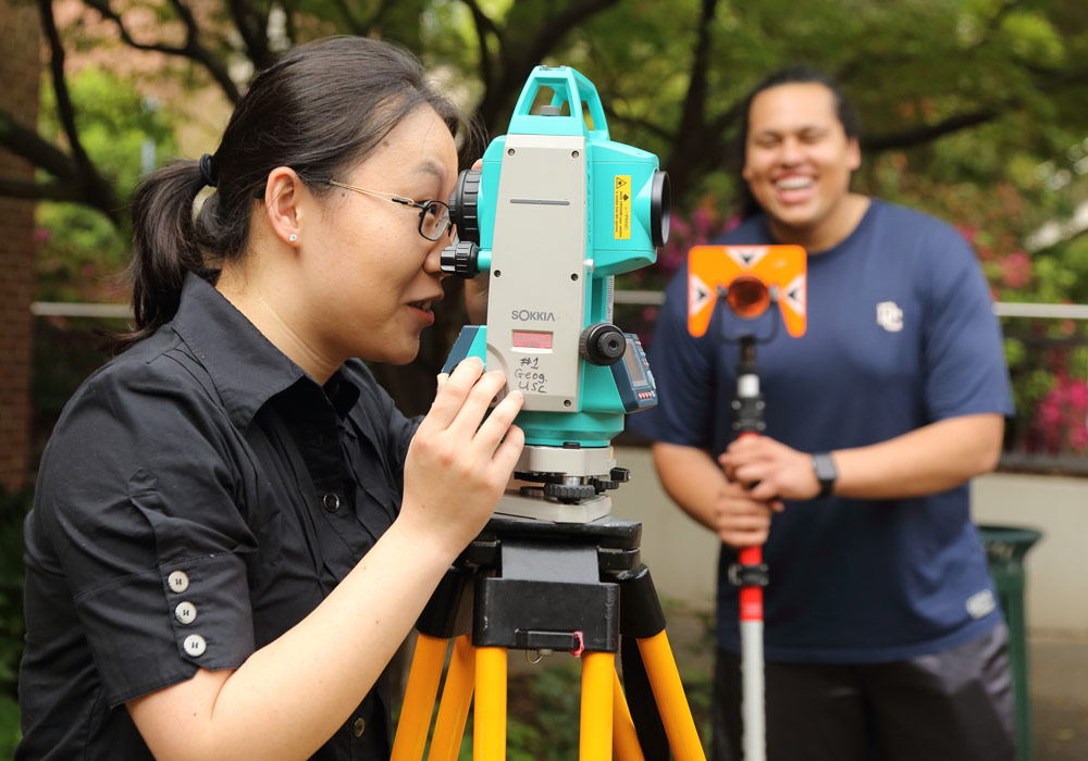 Geography students with surveyor.