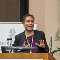 woman speaking at a Podium