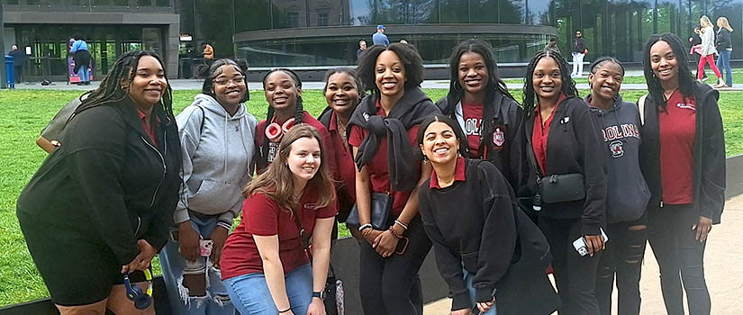 diverse group of students posing outside