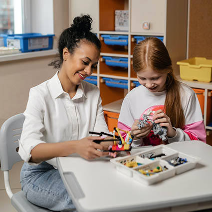 teacher and student working together at a desk