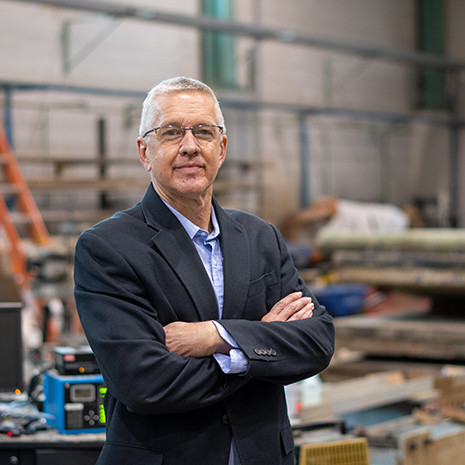 Dr. Ziehl stands in the civil engineering lab