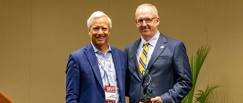 Professor of practice Danny Morrison stands with SEC commissioner Greg Sankey.