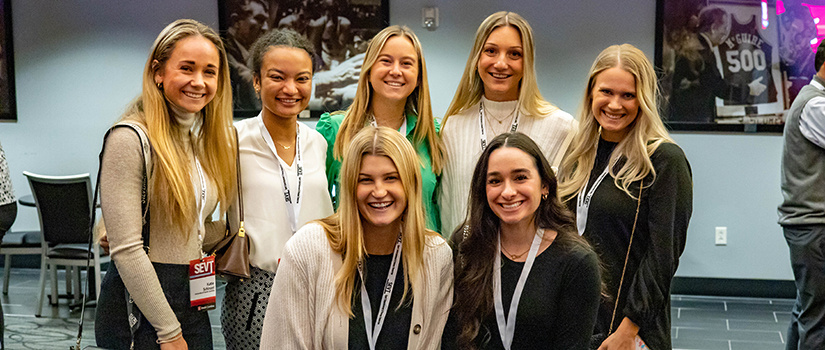 Seven sport and entertainment management majors pose for a photo at the Sport Entertainment and Venues Tomorrow conference.