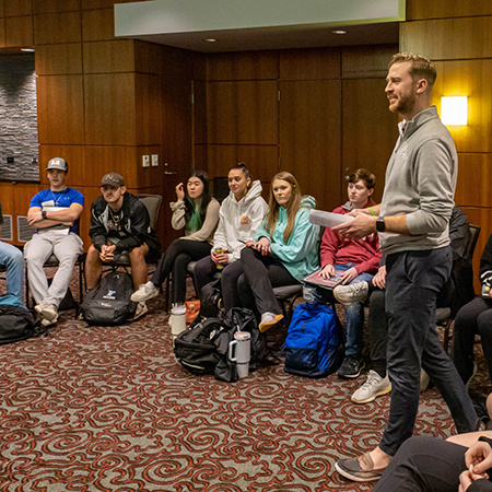 Faculty member Scott Taylor Jr. talks with a group of students during an emotional intelligence seminar.