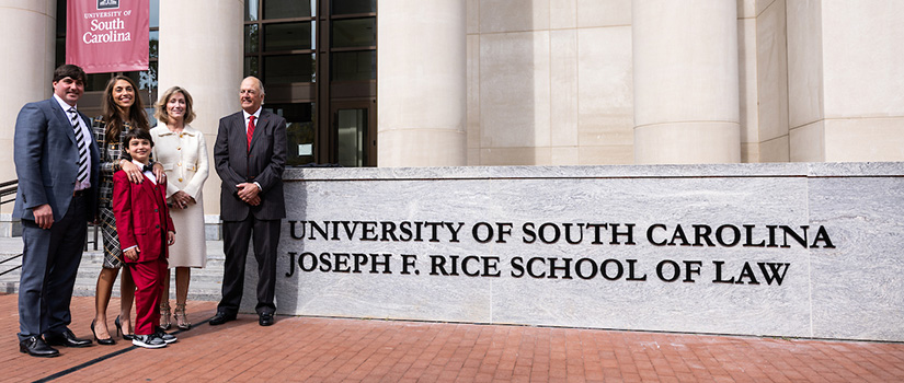 The Rice family standing front of building at naming ceremony