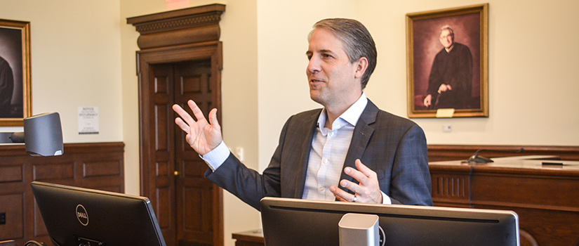 Derek Black lecturing at podium