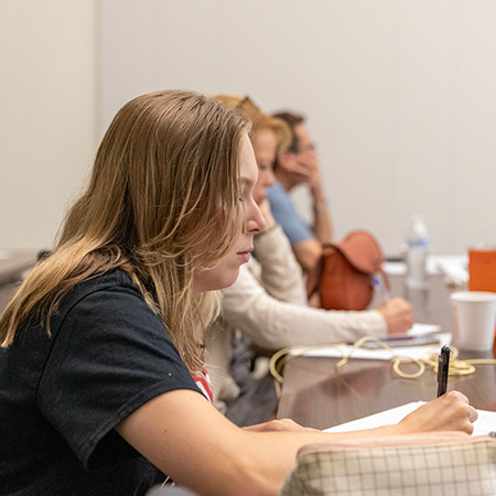 Students taking notes in a classroom