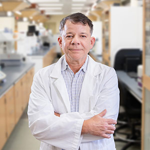 Man in white coat in lab