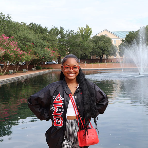 Zoe McDonald in front of the fountain at the Thomas Cooper Library